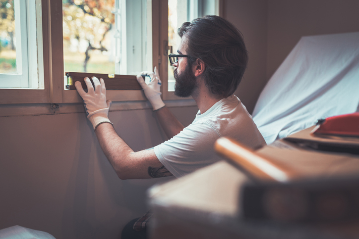 Young man with working tools renovating home